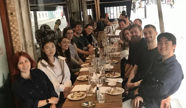 Lab members at a long table outside a restaurant, 2021